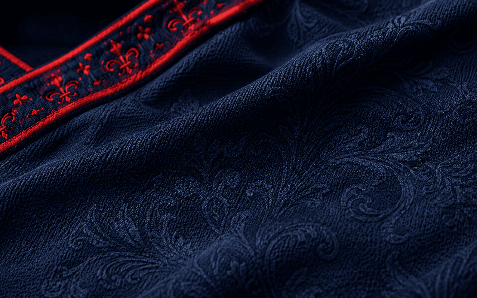 Bleu — macro on shoulder and chest, midnight blue damask floral jacquard, red fleur-de-lis trim band