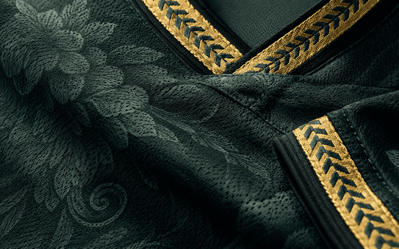 Verde — macro on cuff and side seam, gold chevron trim, dark green Amazon jacquard floral